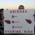 An Arizona Cardinals fan holds up a sign at Phoenix Sky Harbor airport on Monday, January 26, 2009. About 1,000 fans turned out to send the team off to Tampa Bay for Super Bowl XLIII. (Jim Cross/KTAR)