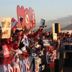The sun rises as Arizona Cardinals fans hold up signs at a Super Bowl XLIII sendoff rally for the team at Phoenix Sky Harbor Airport Monday, January 26, 2009. (Jim Cross/KTAR)