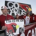 Arizona Cardinals fan Craig Pletzke, of Tempe, Ariz., holds a sign during a rally in support of their football team as they depart for the Super Bowl in Tampa Monday, Jan. 26, 2009, at Sky Harbor International Airport in Phoenix. The Cardinals will play the Pittsburgh Steelers in Super Bowl XLIII in Tampa on Feb. 1. (AP Photo/Paul Connors)