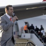 Arizona Cardinals quarterback Kurt Warner addresses a group of fans who turned out for a rally as players board the football team's charter plane bound for the Super Bowl in Tampa Monday, Jan. 26, 2009, at Sky Harbor International Airport in Phoenix. The Cardinals will play the Pittsburgh Steelers in Super Bowl XLIII in Tampa on Feb. 1. (AP Photo/Paul Connors)