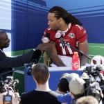 TV analyst Deion Sanders interviews Arizona Cardinals wide receiver Larry Fitzgerald during the team's media day for Super Bowl XLIII Tuesday, Jan. 27, 2009, in Tampa, Fla. The Cardinals will play the Pittsburgh Steelers in the NFL Super Bowl football game on Sunday, Feb. 1. (AP Photo/Gene J. Puskar)