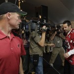 Arizona Cardinals' Ken Whisenhunt, left, leaves the podium as Kurt Warner (13) arrives to speak at a morning news conference at the team hotel Wednesday, Jan. 28, 2009, in Tampa, Fla. The Cardinals will face the Pittsburgh Steelers in Super Bowl XLIII in Tampa, on Sunday. (AP Photo/Ross D. Franklin)