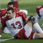 Arizona Cardinals quarterback Kurt Warner (13) stretches with teammates including Matt Leinart, back left, and Deuce Lutui (76) during football practice at the Tampa Bay Buccaneers training facility Wednesday, Jan. 28, 2009, in Tampa, Fla. The Cardinals face the Pittsburgh Steelers in Super Bowl XLIII on Sunday in Tampa. (AP Photo/Ross D. Franklin)