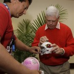 Arizona Cardinals fan Wil Large, left, of Tucson, Ariz., gets a football helmet autographed by former St. Louis Cardinals quarterback Jim Hart as they join dozens attending a pep rally at a local hotel Saturday, Jan. 31, 2009, in Tampa, Fla. The Cardinals face the Pittsburgh Steelers in Super Bowl XLIII in Tampa, on Sunday. (AP Photo/Ross D. Franklin)