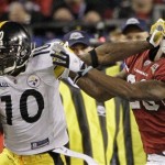 Pittsburgh Steelers wide receiver Santonio Holmes, left, tries to fend off Arizona Cardinals defensive back Dominique Rodgers-Cromartie during the third quarter of the NFL Super Bowl XLIII football game, Sunday, Feb. 1, 2009, in Tampa, Fla.(AP Photo/Mark Humphrey)