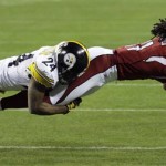 Arizona Cardinals wide receiver Larry Fitzgerald (11) is tackled by Pittsburgh Steelers cornerback Ike Taylor (24) after making a reception during the fourth quarter of the NFL Super Bowl XLIII football game, Sunday, Feb. 1, 2009, in Tampa, Fla. (AP Photo/David J. Phillip)
