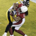 Arizona Cardinals wide receiver Larry Fitzgerald (11) catches a 1-yard touchdown pass in front of Pittsburgh Steelers cornerback Ike Taylor, top, during the fourth quarter of the NFL Super Bowl XLIII football game, Sunday, Feb. 1, 2009, in Tampa, Fla. (AP Photo/Charlie Riedel)