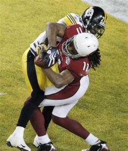 Arizona Cardinals wide receiver Larry Fitzgerald (11) catches a 1-yard touchdown pass in front of Pittsburgh Steelers cornerback Ike Taylor, top, during the fourth quarter of the NFL Super Bowl XLIII football game, Sunday, Feb. 1, 2009, in Tampa, Fla. (AP Photo/Charlie Riedel)