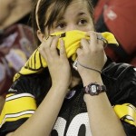 A Pittsburgh Steelers fan reacts as Arizona Cardinals wide receiver Larry Fitzgerald completes his 64-yeard touchdown in the fourth quarter of the NFL Super Bowl XLIII football game, Sunday, Feb. 1, 2009, in Tampa, Fla. (AP Photo/Julie Jacobson)