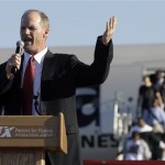 Arizona Cardinals coach Ken Whisenhunt addresses a crowd of supporters as players disembark a charter plane upon arrival from the NFL Super Bowl XLIII football game, Monday, Feb. 2, 2009 in Phoenix. The Cardinals lost to the Pittsburgh Steelers in the Super Bowl on Sunday. (AP Photo/Paul Connors)