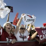 Arizona Cardinals fans Debra Carnahan, left, of Peoria, Ariz., and Marlene Russo, right, of Wickenburg, Ariz., cheer as the team's plane arrives from the NFL Super Bowl XLIII football game, Monday, Feb. 2, 2009 in Phoenix. The Cardinals lost to the Pittsburgh Steelers in the Super Bowl on Sunday. (AP Photo/Paul Connors)