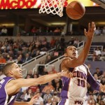 Phoenix Suns Leandro Barbosa, right of Brazil, draws the foul on Sacramento Kings Kevin Martin during the fourth quarter of an NBA basketball game on Monday, Feb. 2, 2009, in Phoenix. (AP Photo/Rick Scuteri)