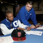 Willie Downs, left, a Godby High School senior, signs his letter of intent to play NCAA college football at Florida State as his high school coach Shelton Crews looks on, Wednesday, Feb. 4, 2009, in Tallahassee, Fla. (AP Photo/Phil Coale)