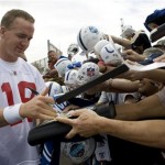 Indianapolis Colts quarterback Peyton Manning signs autographs for fans after AFC Pro Bowl football practice Wednesday, Feb. 4, 2009 in Kapolei, Hawaii. (AP Photo/Marco Garcia)