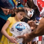 Five-year old Angel Martinez of Seattle, gets her Pro Bowl helmet autographed by Buffalo Bills running back Marshawn Lynch after AFC Pro Bowl football practice Wednesday, Feb. 4, 2009 in Kapolei, Hawaii. (AP Photo/Marco Garcia)