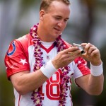 Indianapolis Colts quarterback Peyton Manning looks at the photographs he took on his camera during the AFC Pro Bowl football team photo session at the Ihilani Resort and Spa Friday, Feb. 6, 2009, in Kapolei, Hawaii. (AP Photo/Marco Garcia)