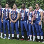 New York Giants football players from left to right, Zak DeOssie (51), Eli Manning (10), Chris Snee (76), Justin Tuck (91), John Carney (5), Shaun O'Hara (60), and Jeff Feagles (18) pose for photos with hula dancers before an NFC practice at the Ko Olina Resort in Kapolei, Hawaii, Friday Feb. 6, 2009, in preparation for the Pro Bowl football game this Sunday. (AP Photo/Ronen Zilberman)