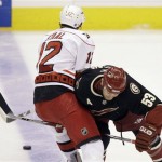 Phoenix Coyotes defenseman Derek Morris, right, checks Carolina Hurricanes center Eric Staal, left, as Staal attempts to carry the puck into the Coyotes' zone in the first period of an NHL hockey game Saturday, Feb 7, 2009, in Glendale, Ariz. (AP Photo/Paul Connors)