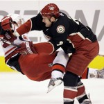 Phoenix Coyotes defenseman Ken Klee, right, checks Carolina Hurricanes right winger Justin Williams, left, to the ice in the first period of an NHL hockey game Saturday, Feb 7, 2009, in Glendale, Ariz. (AP Photo/Paul Connors)