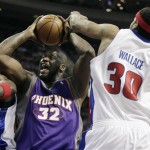 Phoenix Suns' Shaquille O'Neal (32) goes to the basket against Detroit Pistons' Antonio McDyess, left, and Rasheed Wallace (30) in the first half of an NBA basketball game Sunday, Feb. 8, 2009, in Auburn Hills, Mich. (AP Photo/Duane Burleson)