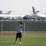 Cleveland Indians catcher Victor Martinez catches a ball in front of stored airplanes at the nearby Goodyear Airport on reporting day for pitchers and catchers at spring training baseball Thursday, Feb 12, 2009, in Goodyear, Ariz. (AP Photo/Paul Connors)