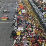 Cars line up for fuel and tires along pit road during the NASCAR Daytona 500 auto race at Daytona International Speedway in Daytona Beach, Fla., Sunday, Feb. 15, 2009. (AP Photo/Don Montague)