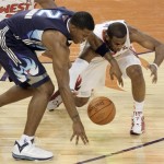 Western All-Star Chris Paul, right, of the New Orleans Hornets, and Eastern All-Star Joe Johnson (2), of the Atlanta Hawks, reach for a loose ball during the first half of the NBA All-Star basketball game Sunday, Feb. 15, 2009, in Phoenix. (AP Photo/Matt Slocum)