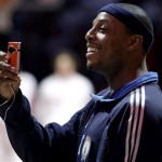 Eastern All-Star Paul Pierce (34), of the Boston Celtics, uses a digital camera during the NBA All-Star basketball game Sunday, Feb. 15, 2009, in Phoenix. (AP Photo/Ross D. Franklin)