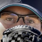 Seattle Mariners pitcher Ryan Rowland-Smith looks into his glove as he prepares to throw a pitch on the first day of baseball spring training Saturday, Feb. 14, 2009 in Peoria, Ariz. (AP Photo/Charlie Riedel)