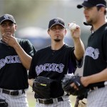 Colorado Rockies pitchers wait for their turn during a drill, including Randy Flores, center, Monday, Feb. 23, 2009, during spring training baseball in Tucson, Ariz. (AP Photo/Elaine Thompson)