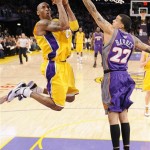 Los Angeles Lakers guard Kobe Bryant, left, goes up for a shot as Phoenix Suns forward Matt Barnes (22) defends during the first half of their NBA basketball game Thursday, Feb. 26, 2009, in Los Angeles. (AP Photo/Mark J. Terrill)