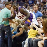 Phoenix Suns Jason Richardson (23) leaps from the audience after diving for a loose ball against the Toronto Raptors in the second quarter of an NBA basketball game in Phoenix on Friday, Feb. 27, 2009. (AP Photo/Aaron J. Latham)