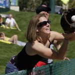 Michelle German of Gilbert, Ariz., reaches out for a ball thrown to her as the Kansas City Royals take batting practice before a spring training baseball game against the Los Angeles Angels in Tempe, Ariz., Sunday, March 1, 2009. (AP Photo/Eric Risberg)