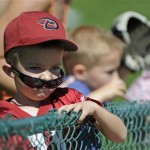 Keeton Bell, 5, of Mesa, Ariz., watches from the left field fence as the Kansas City Royals take batting practice before their spring training baseball game against the Los Angeles Angels in Tempe, Ariz., Sunday, March 1, 2009. (AP Photo/Eric Risberg)