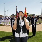 The Los Angeles Dodgers and Chicago White Sox watch as Jordin Sparks sings the national anthem before the Dodgers' first spring training baseball game to be played at Camelback Ranch on Sunday, March 1, 2009, in Phoenix. (AP Photo/Morry Gash)