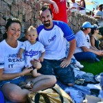 Jackie, Troy, and baby Braden Antinucci, from Yucaipa, California, soak up the sun at the Dodgers-White Sox spring training baseball game Sunday, March 1, 2009, in Phoenix. (Rose Clements/KTAR)