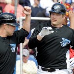 Toronto Blue Jays' Adam Lind, right, is greeted by Aaron Hill after hitting a two-run, first-inning homer off Philadelphia Phillies pitcher J.A. Happ in a spring training baseball game in Dunedin, Fla., Monday, March 2, 2009. (AP Photo/Gene J. Puskar)
