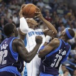 New Orleans Hornets forward David West (30) is sandwiched between Dallas Mavericks' Jason Terry (31) and Brandon Bass (32) in the first half of an NBA basketball game in New Orleans, Thursday, March 5, 2009. (AP Photo/Bill Haber)