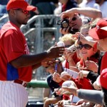 Philadelphia Phillies' Ryan Howard, left, signs autographs for fans before an exhibition spring baseball game against Canada in Clearwater, Fla., Wednesday, March 4, 2009. (AP Photo/Gene J. Puskar)
