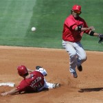 Los Angeles Angels shortstop Erick Aybar, right, throws to first to complete a double play after forcing Arizona Diamondbacks Conor Jackson (34) out at second on Saturday, March 7, 2009, during an second inning of an exhibition spring baseball game in Tucson, Ariz. Arizona's Chad Tracy was out at first. (AP Photo/Ed Andrieski)