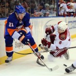 New York Islanders' Kyle Okposo (21) gets off a pass as Phoenix Coyotes' Scottie Upshall (8) goes down trying to stop him in the first period of an NHL hockey game Sunday, March 8, 2009 in Uniondale, N.Y. (AP Photo/Paul J. Bereswill)