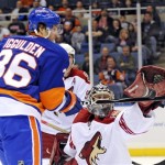 New York Islanders' Mike Iggulden (36) tries to tip the puck on goal as Phoenix Coyotes goalie Josh Tordjman (42) makes the save in the first period of an NHL hockey game Sunday, March 8, 2009 in Uniondale, N.Y. (AP Photo/Paul J. Bereswill)