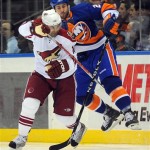 New York Islanders' Joe Callahan, right, is sent into the air by Phoenix Coyotes' Nigel Dawes (14) in the second period of an NHL hockey game Sunday, March 8, 2009 in Uniondale, N.Y. (AP Photo/Paul J. Bereswill)