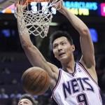 New Jersey Nets' Yi Jianian (9), of China, dunks the ball as New York Knicks' Danilo Gallinari, of Italy, looks on during the second quarter of an NBA basketball game Sunday, March 8, 2009 in East Rutherford, N.J. (AP Photo/Bill Kostroun)