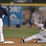 Australia's Ben Risinger, right, beats the tag at second by Seattle Mariners shortstop Yuniesky Betancourt (7) after hitting a double during the second inning of an exhibition spring training baseball game Wednesday, March 4, 2009, in Peoria, Ariz. (AP Photo/Charlie Riedel)
