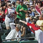 The fans react as Arizona Diamondbacks third baseman Chad Tracy tries to catch a foul ball off of the bat of Los Angeles Angels Reggie Willits during the fourth inning of an exhibition spring baseball game in Tucson, Ariz., Saturday, March 7, 2009. Tracy missed the catch. (AP Photo/Ed Andrieski)
