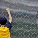 Anthony Ramirez, 8, of Galt, Calif., watches as the Milwaukee Brewers take batting practice before a spring training baseball game against the Colorado Rockies Tuesday, March 3, 2009, in Phoenix. (AP Photo/Morry Gash)