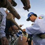 South Korea pitcher Ryu Hyun-jin signs autographs for fans before an exhibition spring baseball game against the San Diego Padres in Peoria, Ariz., Wednesday, March 11, 2009. (AP Photo/Tony Gutierrez)