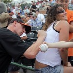 Carrie Suhr, right, of Grass Valley, Calif., smiles while getting the back of her shirt autographed by San Francisco Giants pitcher Brandon Medders, left, before their spring training baseball game against the Arizona Diamondbacks in Scottsdale, Ariz., Tuesday, March 3, 2009. (AP Photo/Eric Risberg)