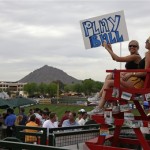 "Inning girls" Jenna Gamble, left, of Tucson, Ariz., and Rachel Mondeau, right, of Scottsdale, Ariz., sit in a lifeguard's chair above right field at Scottsdale Stadium during the San Francisco Giants spring training baseball game against the Arizona Diamondbacks in Scottsdale, Tuesday, March 3, 2009. The women hold up signs when the innings change and at other points during the game at the beach-themed fan pavilion run by the Scottsdale Charros Lodge. (AP Photo/Eric Risberg)